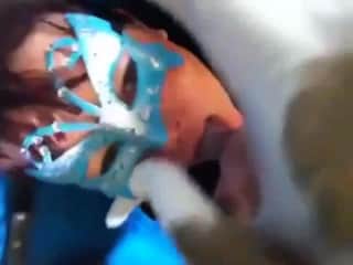 A charming woman wearing a blue mask is delighted to enjoy intense vocal expression