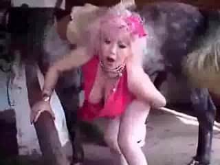 Busty mature slut enjoys sex with a horse