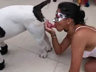 Young girl licking her dog