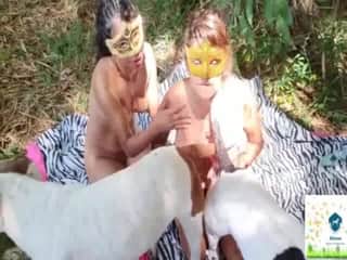 Appealing Hispanic women attending to a beast's member while in nature